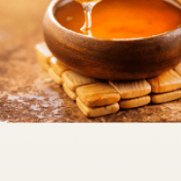Wooden bowl with honey dipper